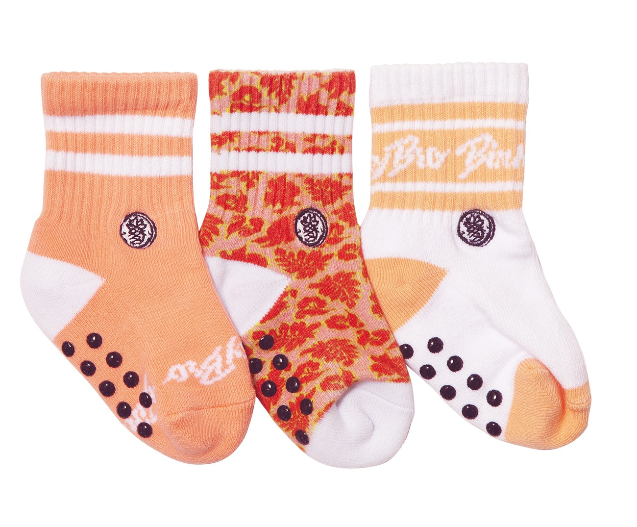 Three pairs of colorful toddler socks featuring peach hues, floral patterns, and non-slip grips, perfect for active little ones.
