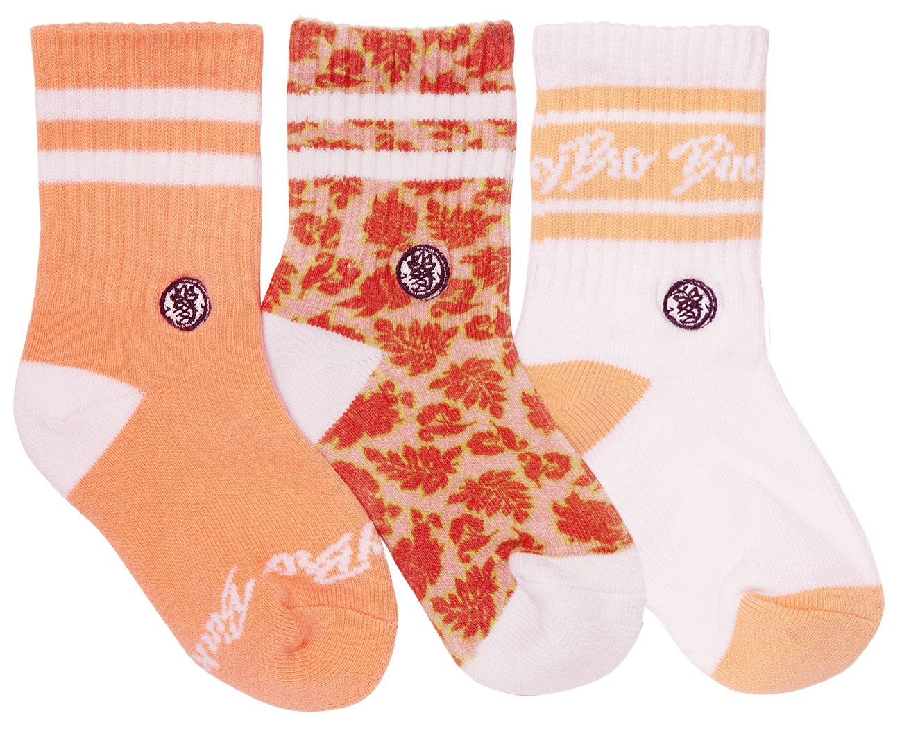 Three pairs of socks featuring peach and floral designs, perfect for kids. Includes solid orange, patterned, and white with stripes.