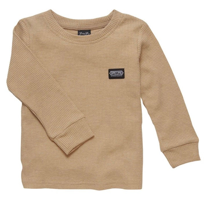 Tan long-sleeve shirt with a textured fabric and a small logo patch, designed for infants and toddlers.