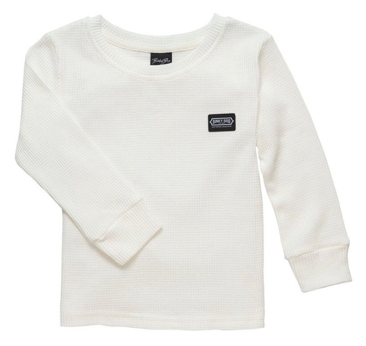 White long-sleeve thermal shirt for kids featuring a small logo patch on the chest, perfect for layering in cool weather.