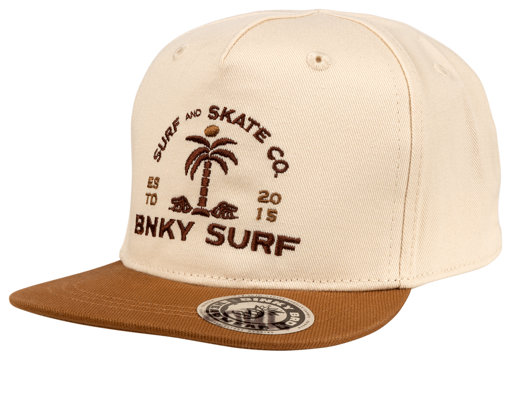 The Rockswell snapback hat has all beige paneling with an embroidered BNKY logo on front and a brown bill. This hat is 100% cotton. This hat is part of our toddler snapbacks collection.