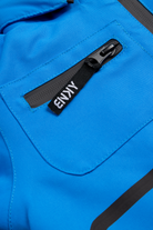 Close-up of a cobalt blue fabric featuring a zippered pocket with a black tag labeled "BNKY," showcasing stylish design details.