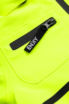 Close-up of a bright chartreuse jacket featuring a zippered pocket and a black zipper pull, showcasing a stylish design for kids.
