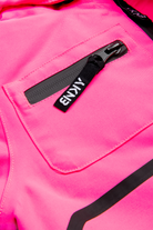Bright pink fabric featuring a zippered pocket with a black pull tab, showcasing the stylish design of the BNKY Knockout Pink.