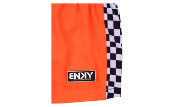 Bright orange shorts featuring a black and white checkered side panel and a branded patch, perfect for active kids.