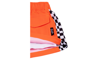 Bright orange Harada shorts featuring a checkered pattern on the inner lining, perfect for stylish, active kids.