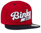 Red snapback hat with a black brim featuring the embroidered text "Binky Bro" in white, designed for kids.