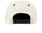 Back view of a cream-colored snapback hat featuring a black adjustable strap, designed for stylish youth apparel.