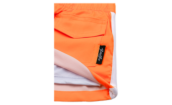 Close-up of Blaze Tangerine shorts featuring a vibrant orange color and a small BinkyBro label on the pocket.
