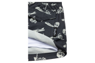Stylish black swim trunks featuring a playful crossbones and skeleton design, perfect for kids' summer adventures.