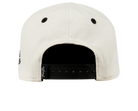 Back view of the Durban SB snapback hat in cream with a black adjustable strap and ventilation holes.
