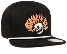 Black snapback hat featuring a skull with fiery orange flames, designed for a stylish surf-snow-skate look for youth.