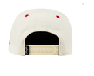 Back view of a cream-colored snapback hat featuring red stitching and an adjustable strap, designed for kids.