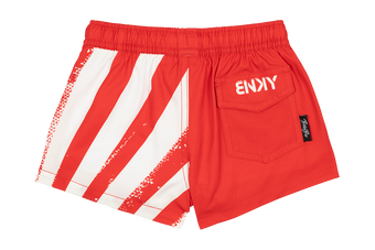 Red swim shorts with white diagonal stripes and a back pocket featuring the brand logo, designed for kids.
