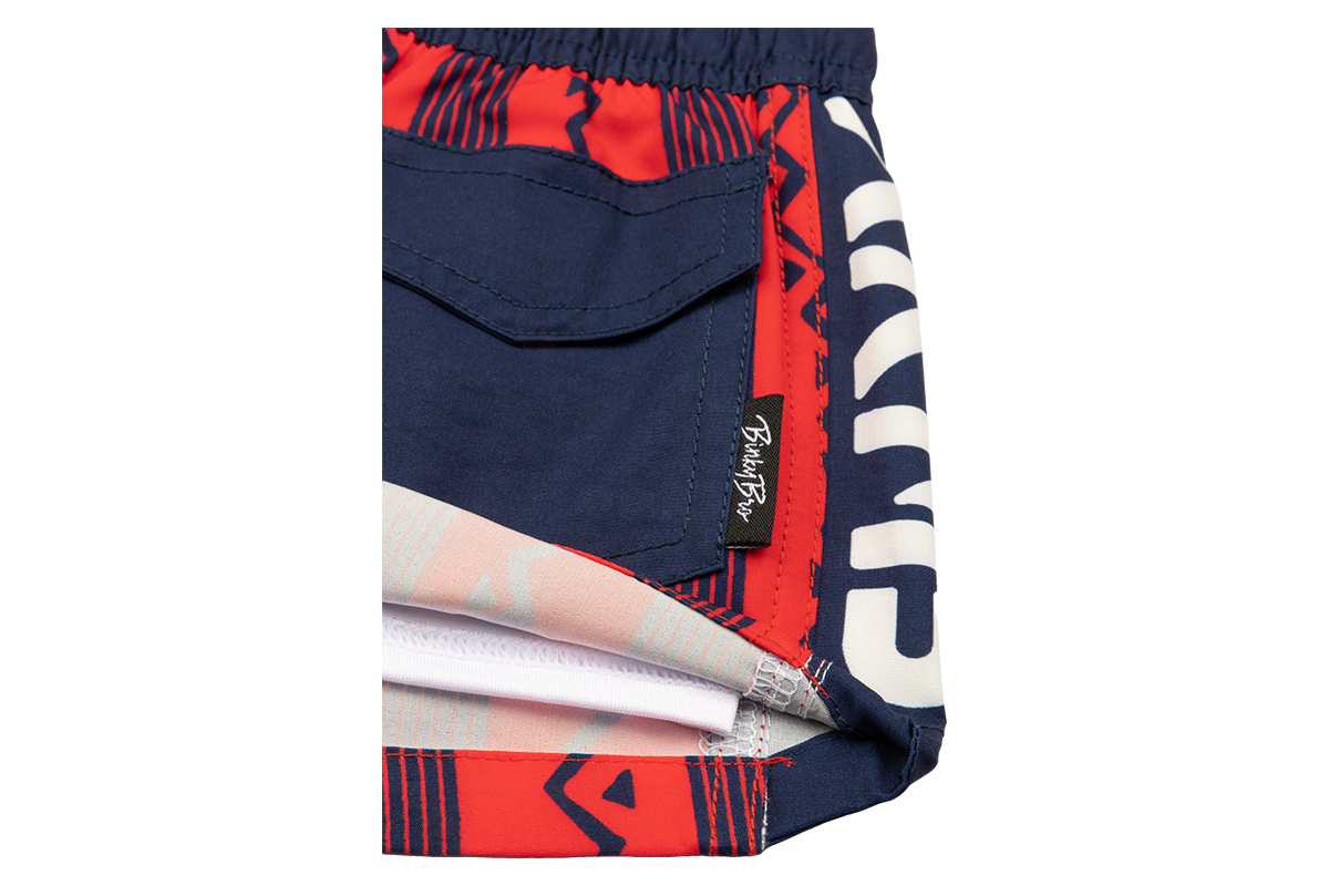Stylish Stamped Crimson swim shorts featuring a mix of vibrant red and navy colors, perfect for active kids.