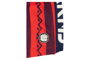Stamped Crimson swim shorts featuring bold red and navy patterns with a BinkyBro logo patch on the side.