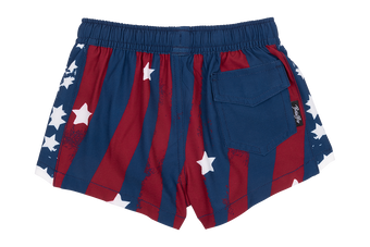 Red and blue swim shorts featuring a star-spangled design with white stars and a back pocket, perfect for summer fun.