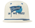 Cream snapback hat featuring a blue embroidered flag with the text "Skating In We Trust" for a stylish, youthful look.