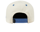 Back view of a cream snapback hat featuring a blue adjustable strap, showcasing a clean and stylish design.